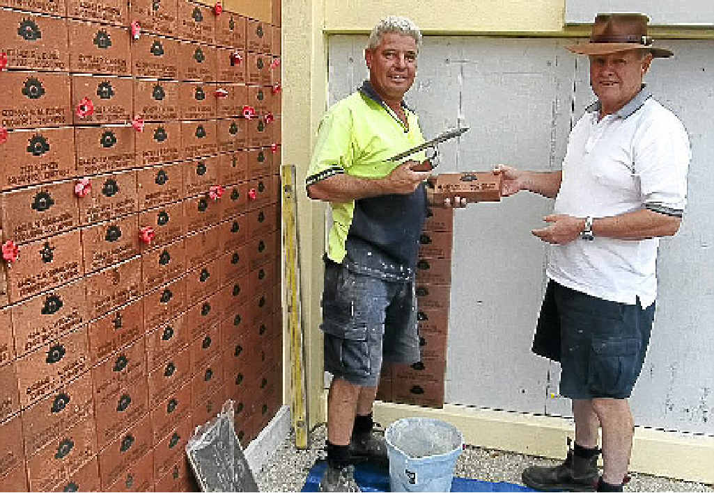 Wayne Sellick and Rod Strahan build the wall. Wayne Sellick and Rod Strahan build the wall.